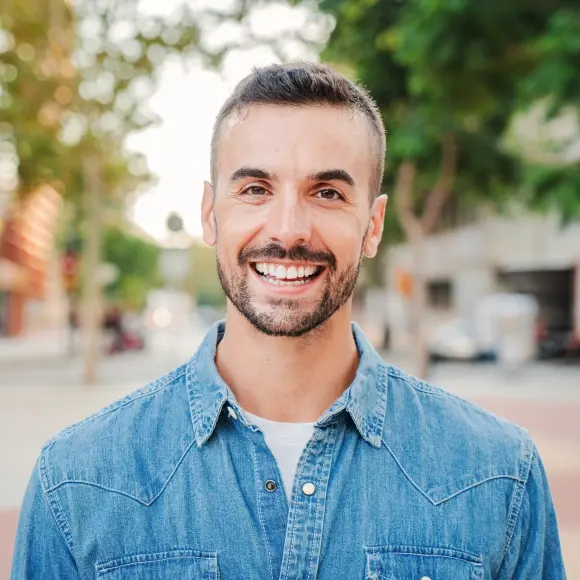 Smiling male patient in denim shirt at Monterey Park dental practice.