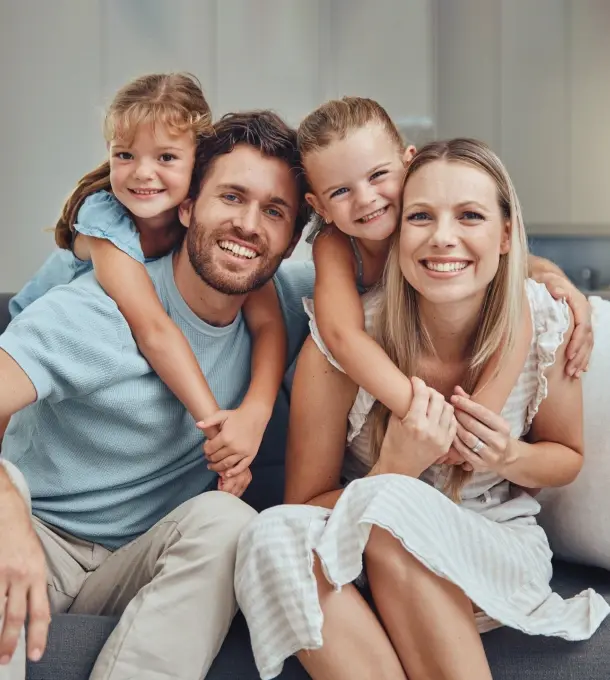 Happy family of four smiling together at Saturday dentist in Monterey Park.